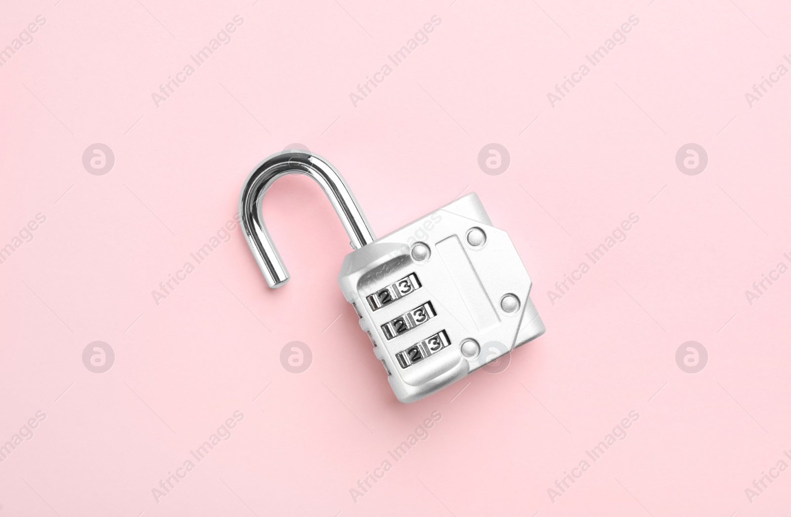 Photo of Modern combination lock on pink background, top view