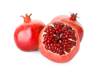 Photo of Many fresh ripe pomegranates isolated on white