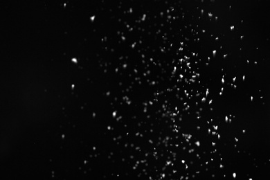 Snow flakes falling on black background. Winter weather