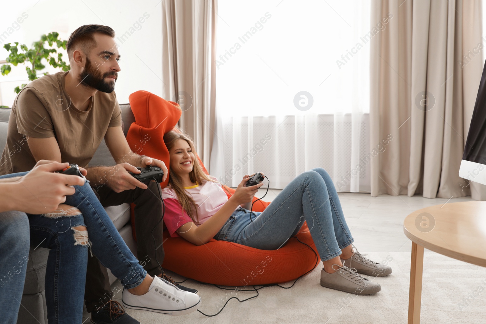 Photo of Emotional friends playing video games at home