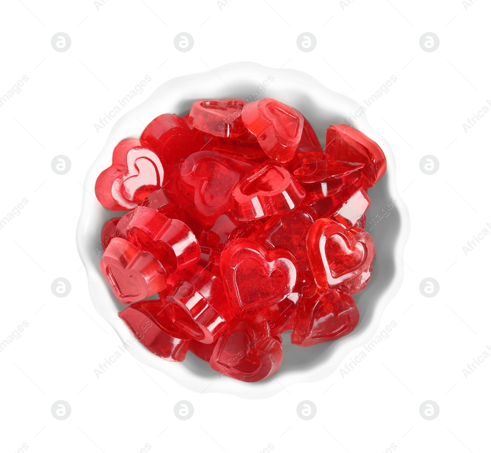 Photo of Sweet heart shaped jelly candies in bowl isolated on white, top view