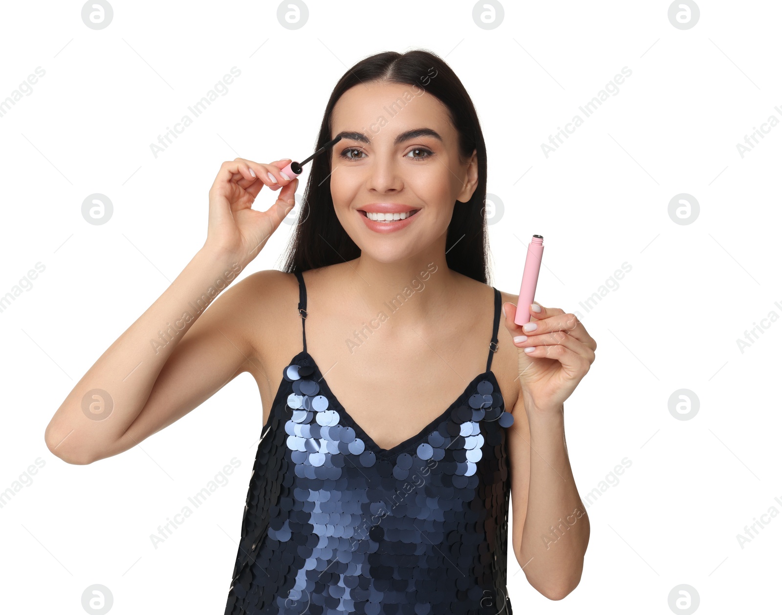 Photo of Beautiful young woman applying mascara on white background