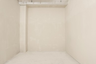 Photo of Empty beautiful clean room with beige walls after renovation