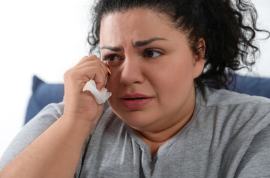 Overweight woman suffering from depression at home