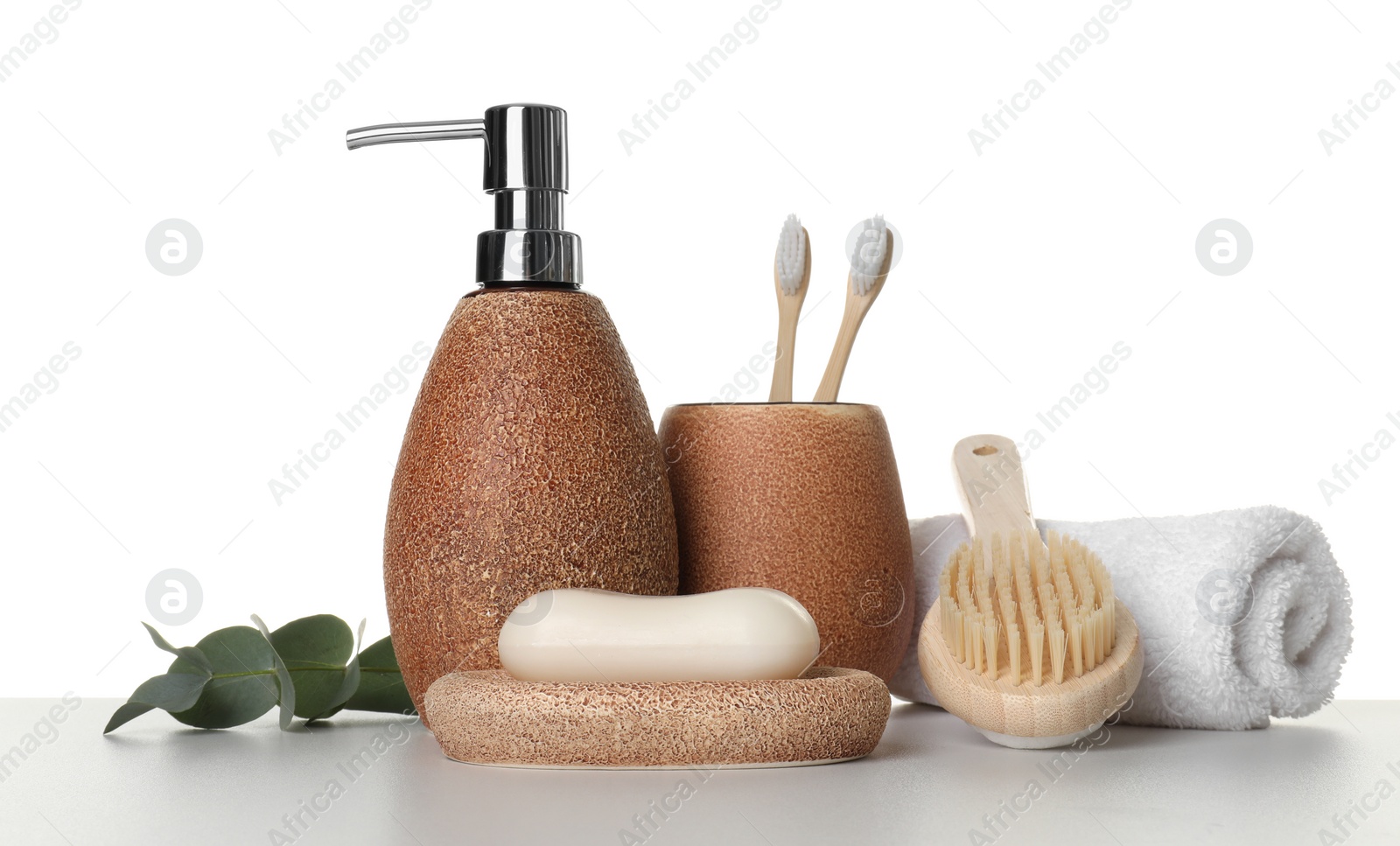 Photo of Bath accessories. Different personal care products and eucalyptus branch on table against white background