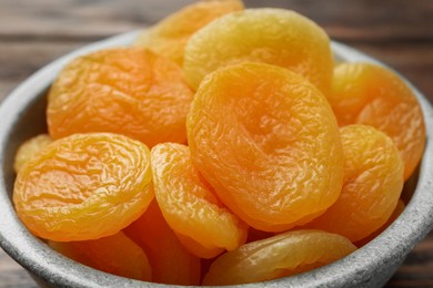 Closeup view of tasty apricots in bowl. Dried fruits