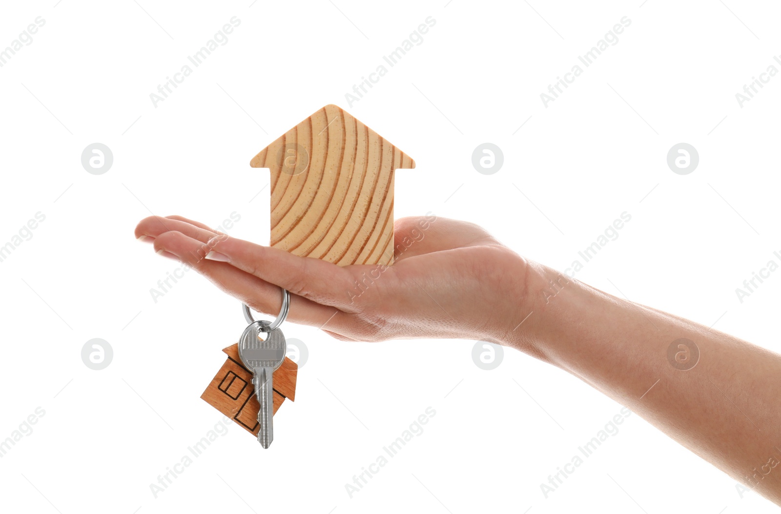 Photo of Real estate agent holding house figure and key on white background, closeup