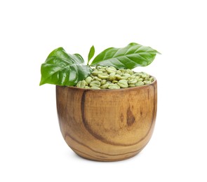 Wooden bowl with green coffee beans and fresh leaves on white background