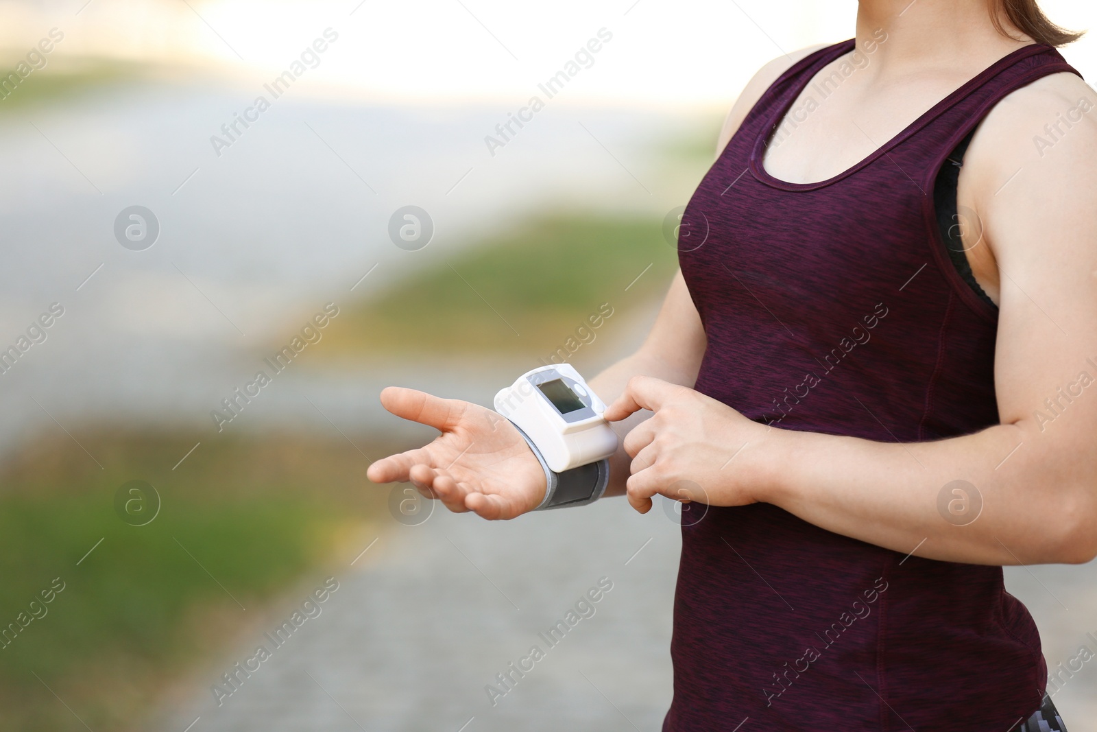Photo of Young woman checking pulse after workout, focus on hands