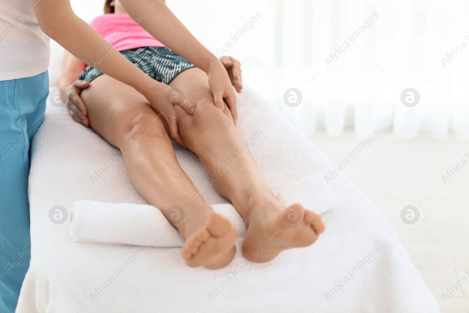 Photo of Woman receiving leg massage in wellness center