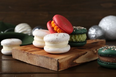 Photo of Beautifully decorated Christmas macarons and festive decor on wooden table