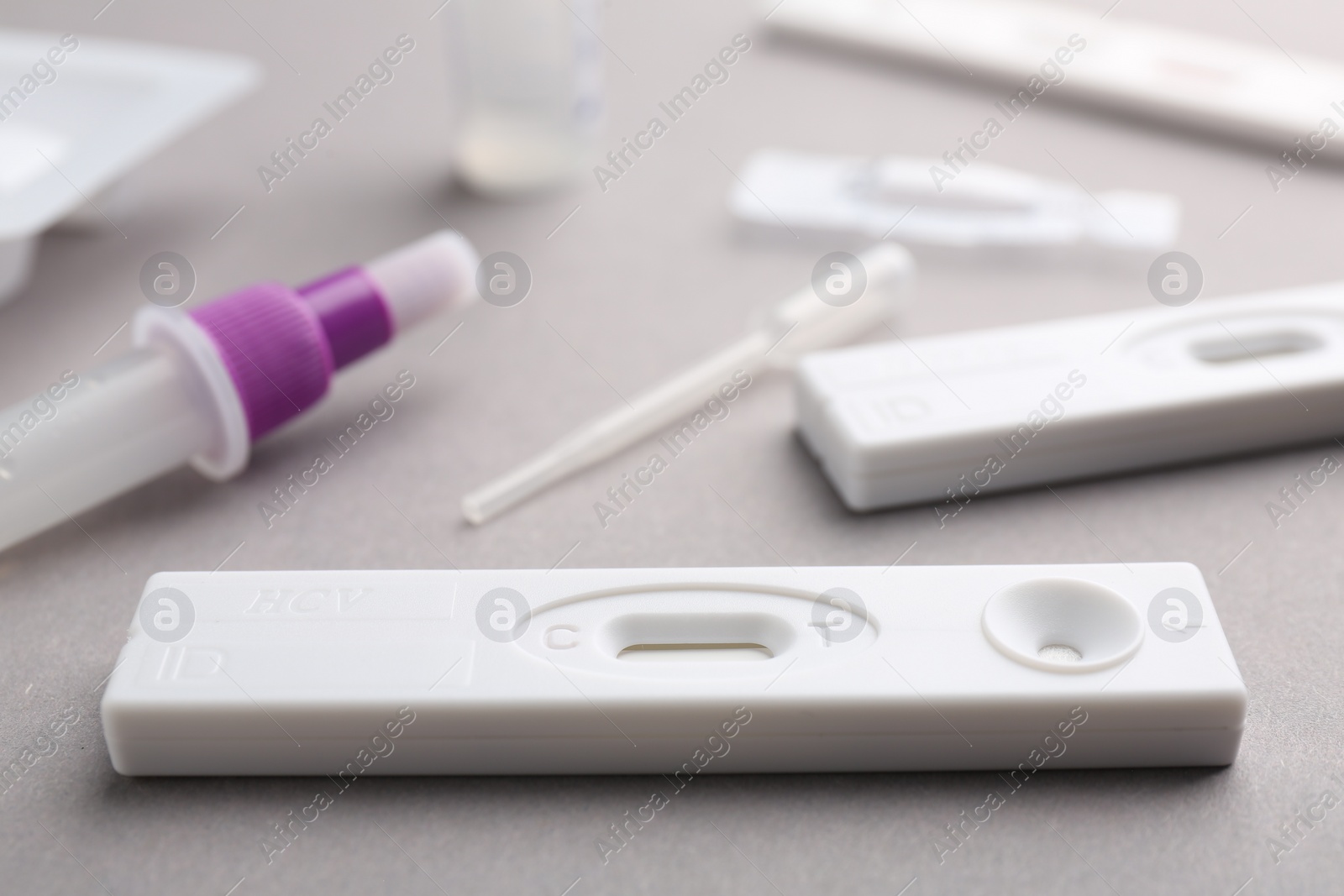 Photo of Disposable express test kits on grey background, closeup