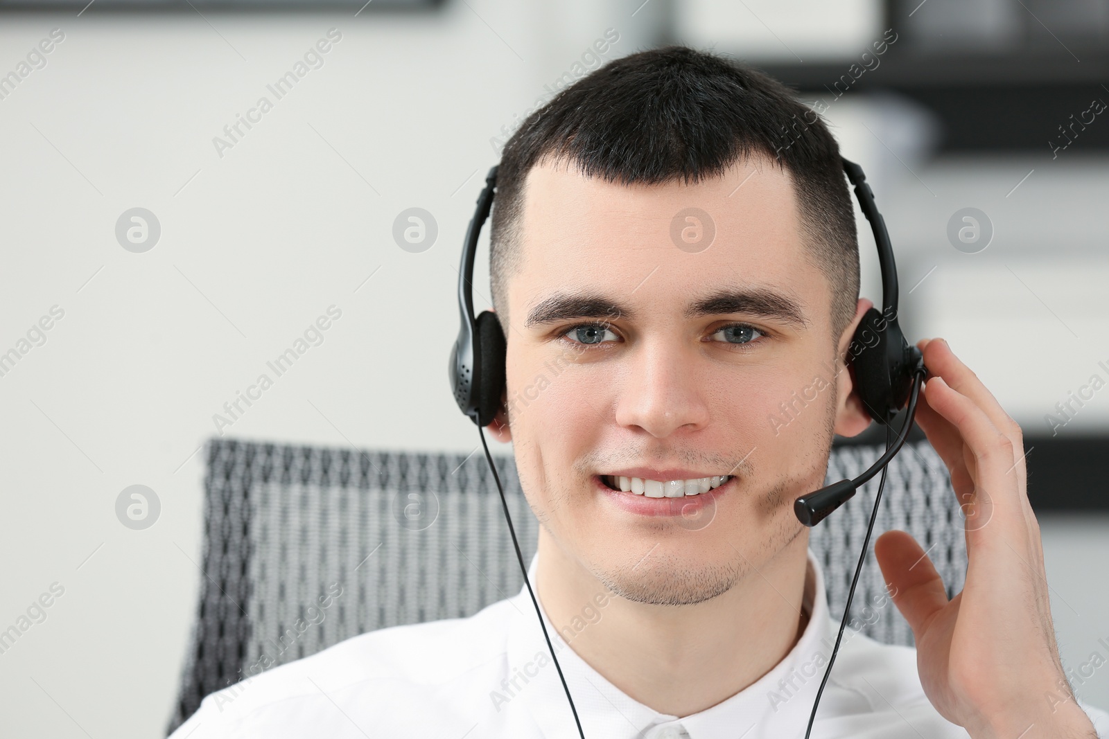 Photo of Hotline operator with headset working in office