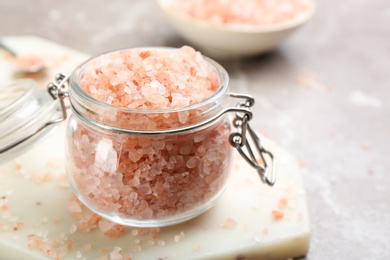 Pink himalayan salt in glass jar on table