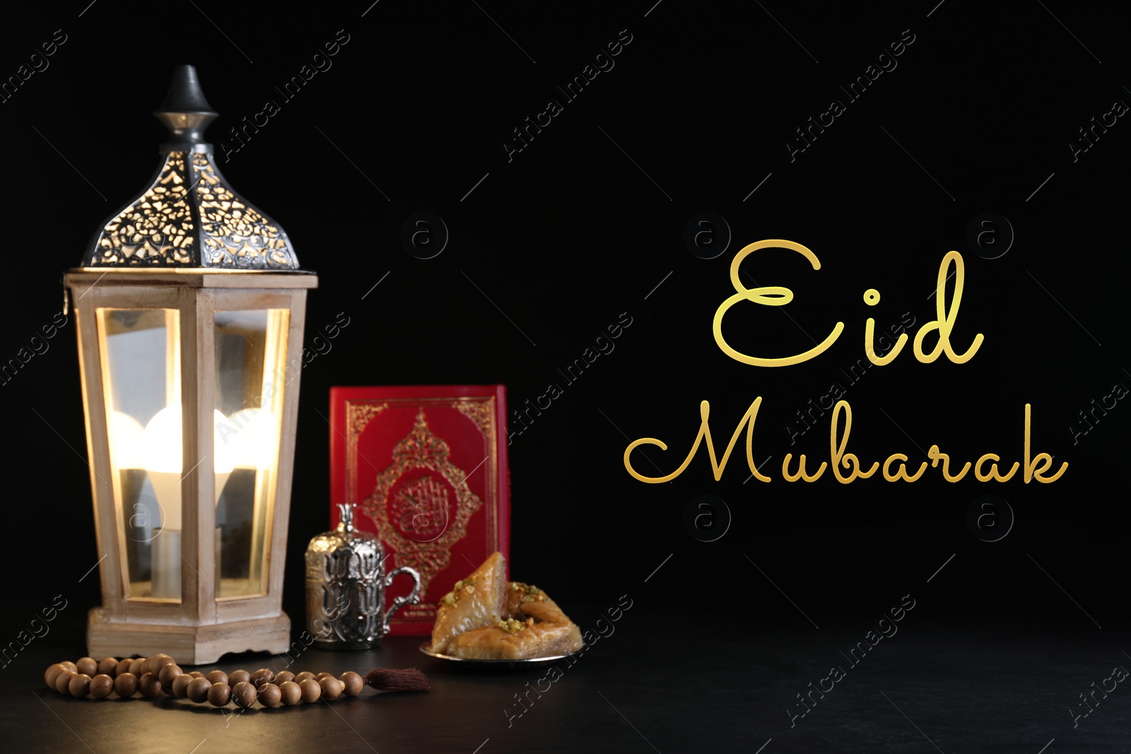 Image of Eid Mubarak greeting card. Composition with Arabic lantern and Quran on table against black background