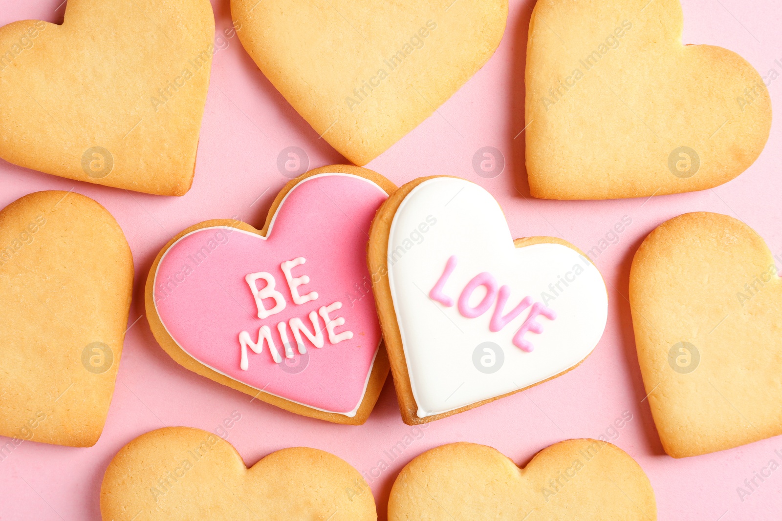 Photo of Decorated heart shaped cookies on color background, top view. Valentine's day treat