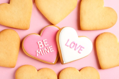 Photo of Decorated heart shaped cookies on color background, top view. Valentine's day treat