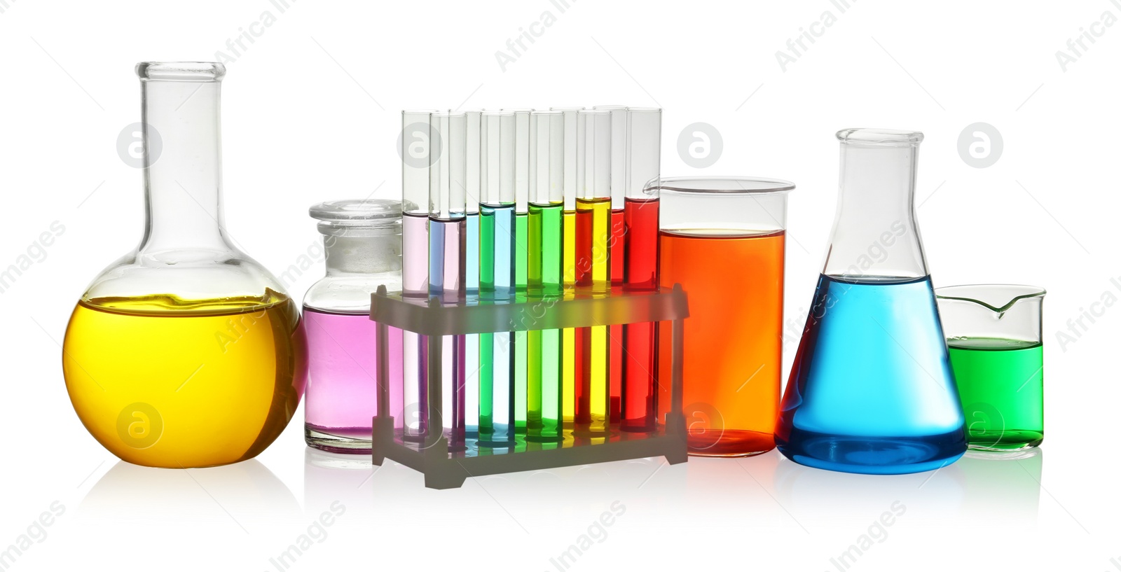 Photo of Laboratory glassware with colorful liquids on white background