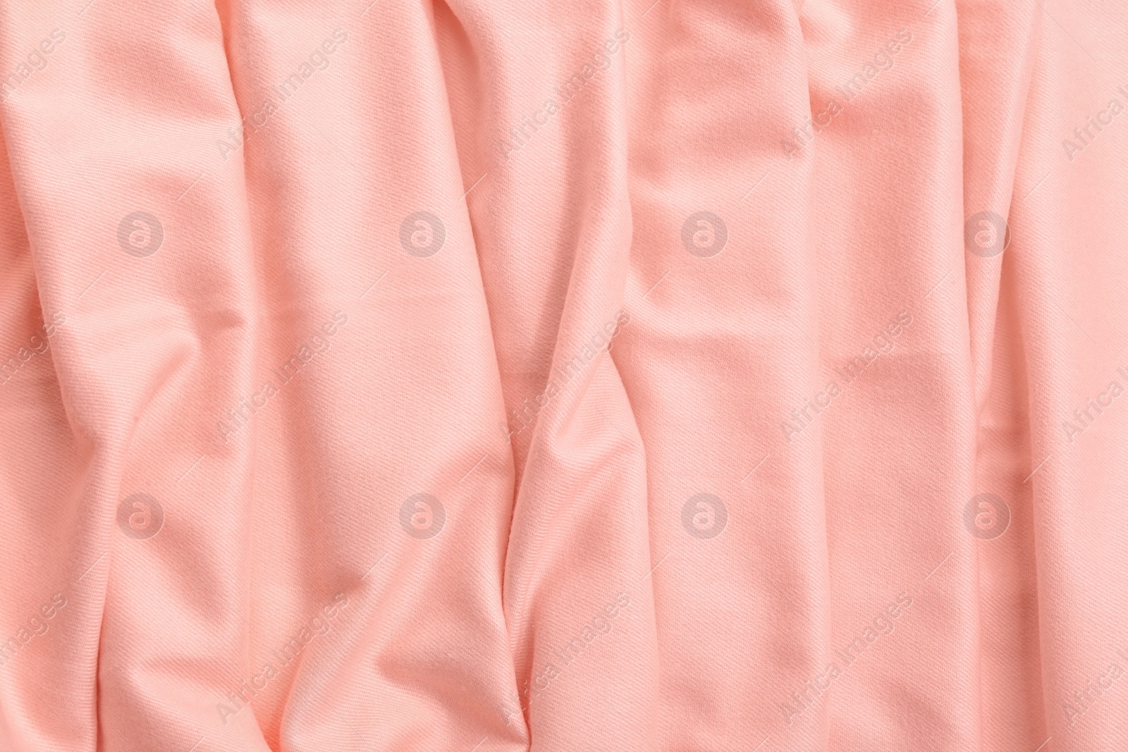 Photo of Elegant peach cloth as background, closeup view