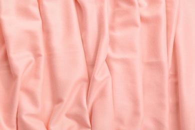 Photo of Elegant peach cloth as background, closeup view