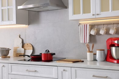 Set of different utensils on countertop in kitchen