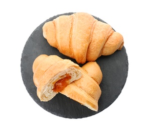 Slate plate with tasty croissants on white background