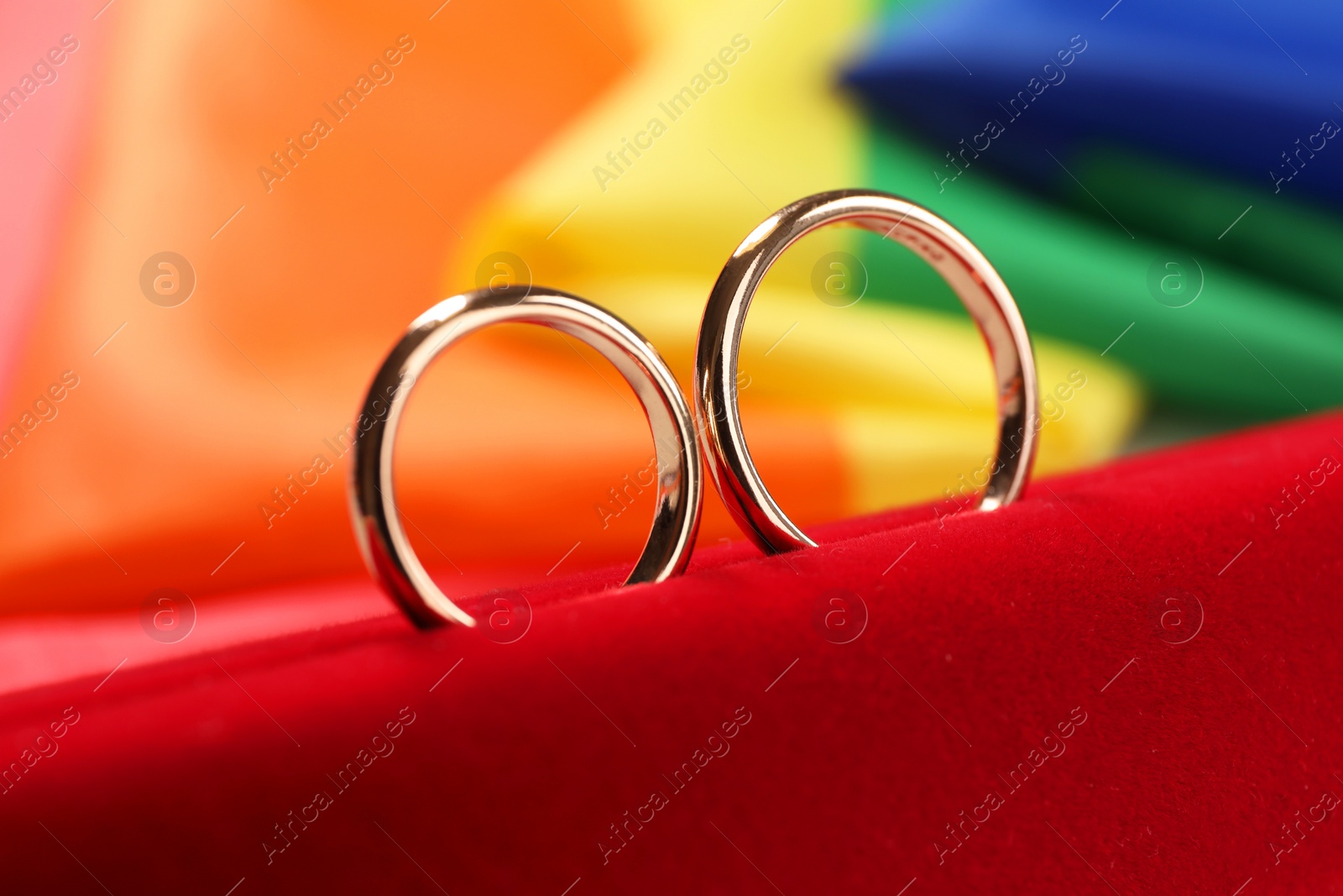 Photo of Wedding rings on rainbow LGBT flag, closeup