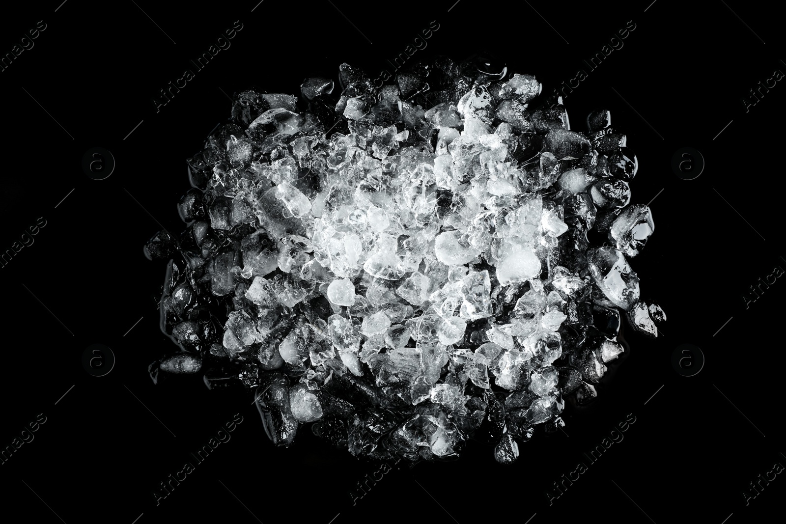 Photo of Heap of crushed ice on black table, top view