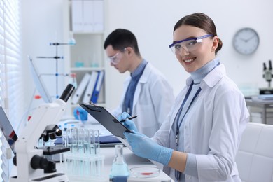 Photo of Scientists working with laboratory test form indoors. Medical research