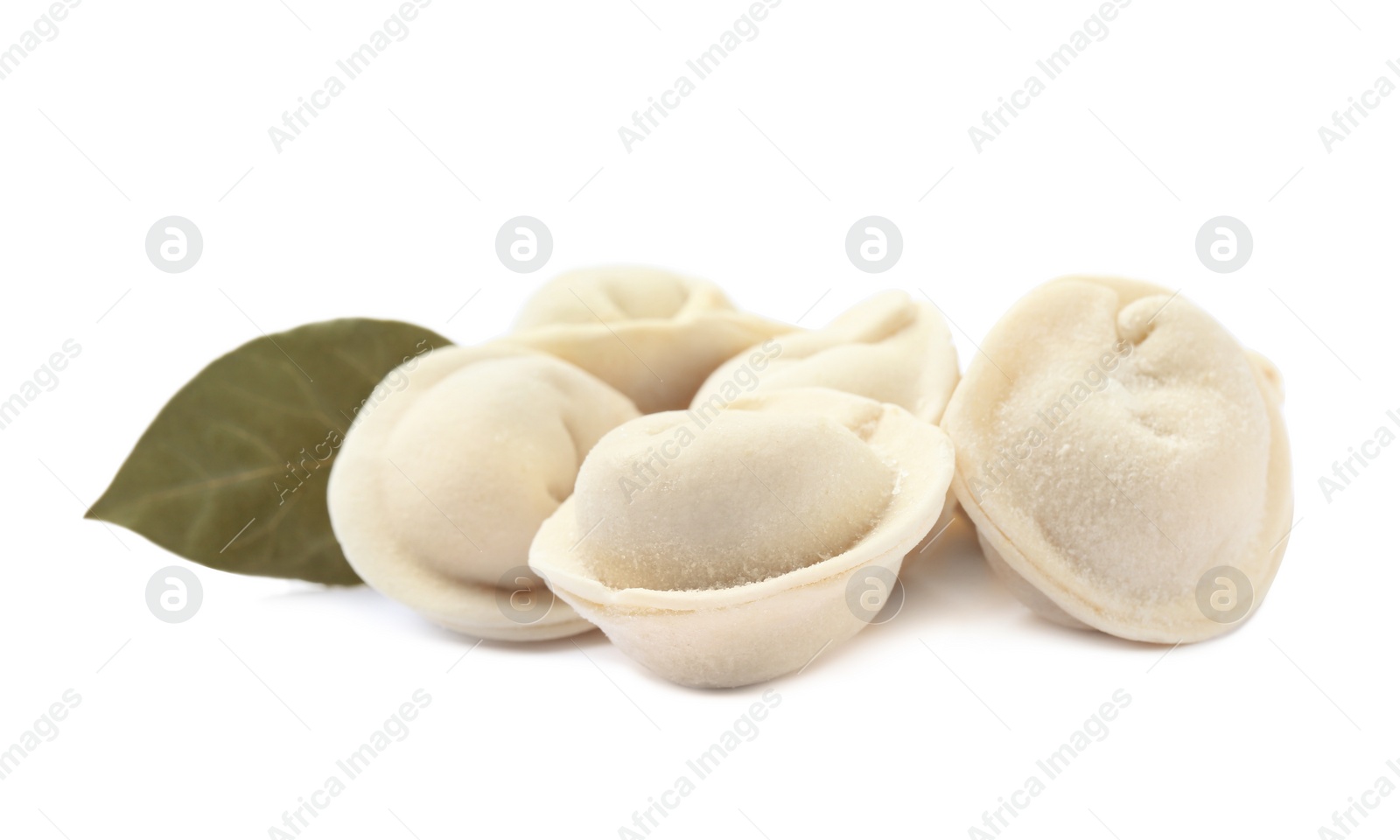 Photo of Pile of raw dumplings with bay leaf on white background