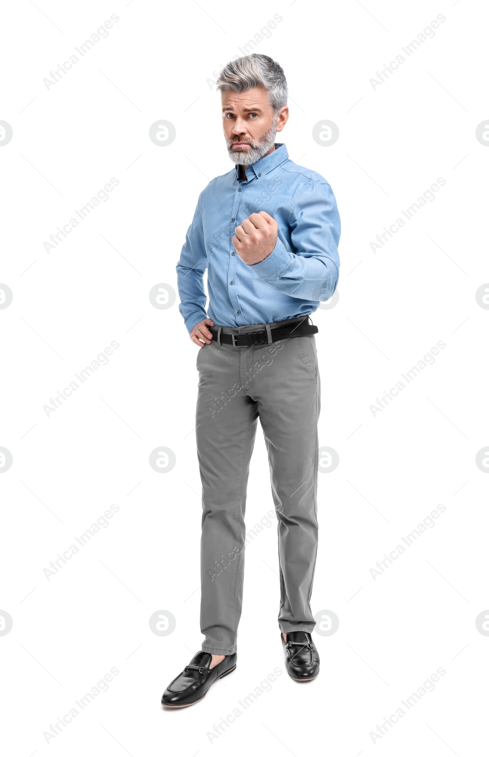 Photo of Mature businessman in stylish clothes posing on white background, low angle view