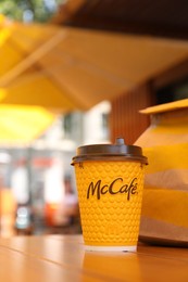 MYKOLAIV, UKRAINE - AUGUST 11, 2021: Hot McDonald's drink and packed food on table in cafe