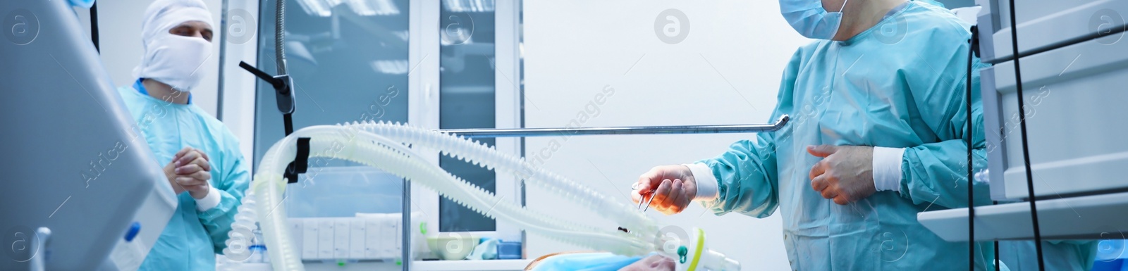 Image of Doctor performing operation in surgery room, closeup. Banner design