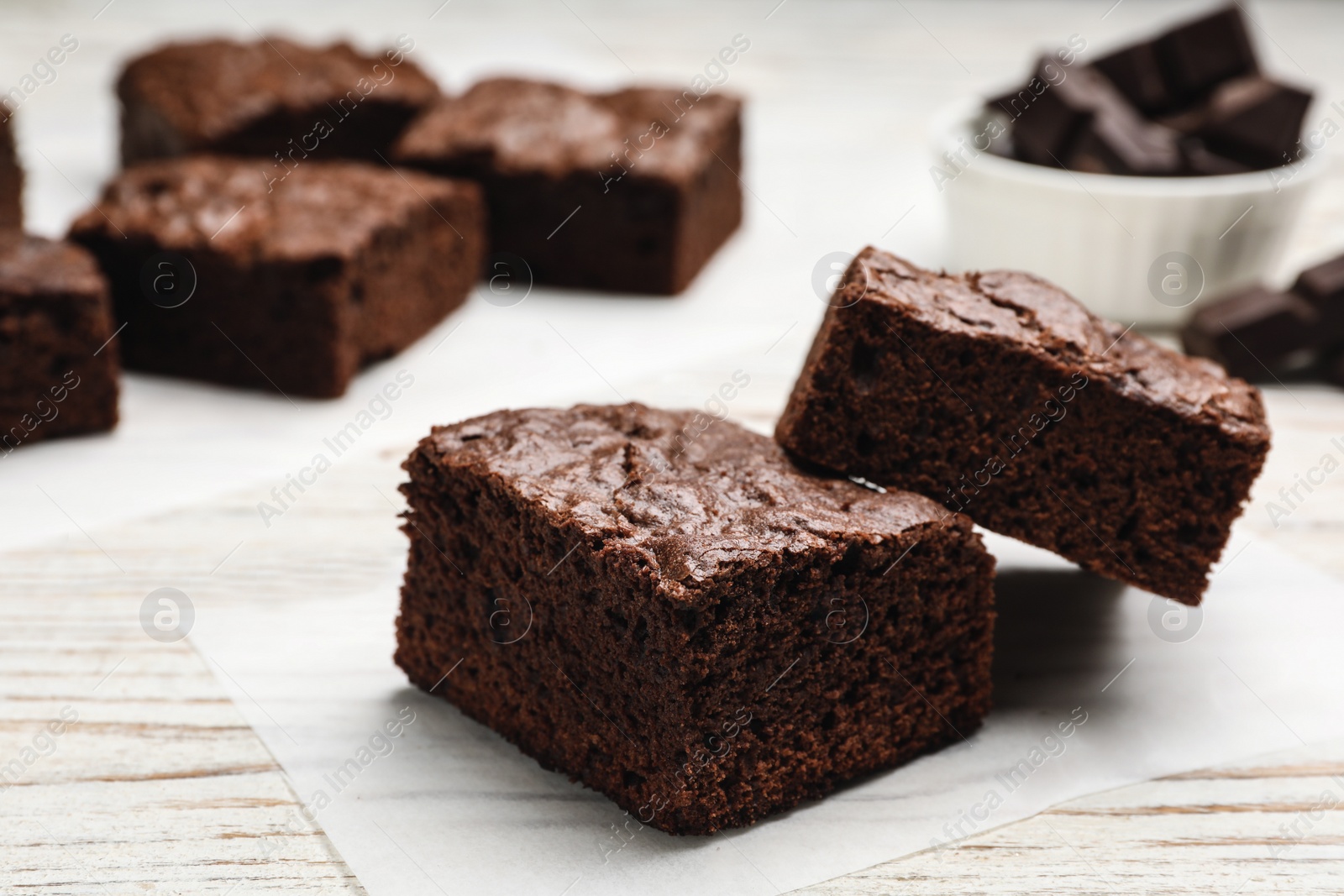 Photo of Fresh brownies on table, closeup. Delicious chocolate pie