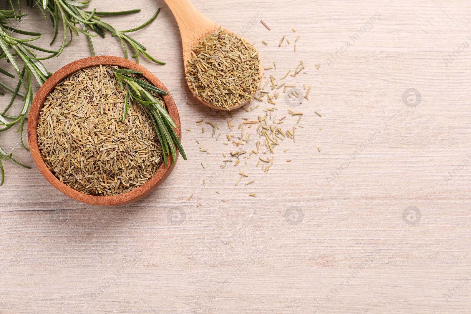 Photo of Dry and fresh rosemary on white wooden table, flat lay. Space for text