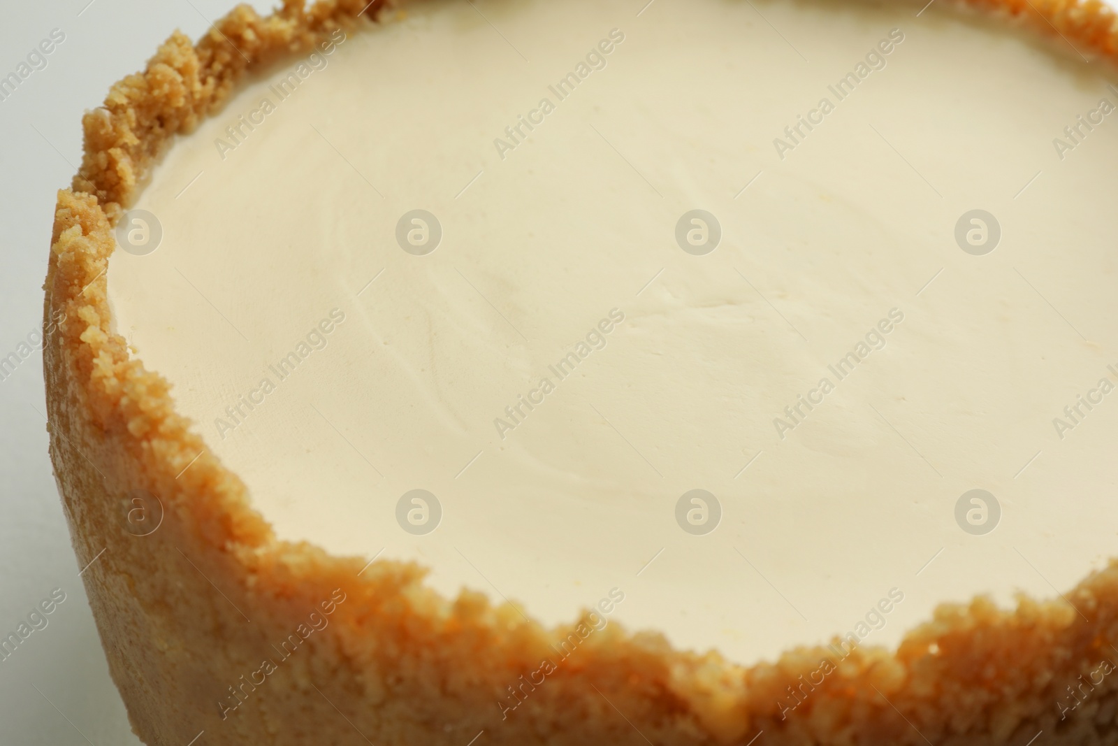 Photo of Tasty vegan tofu cheesecake on white table, closeup
