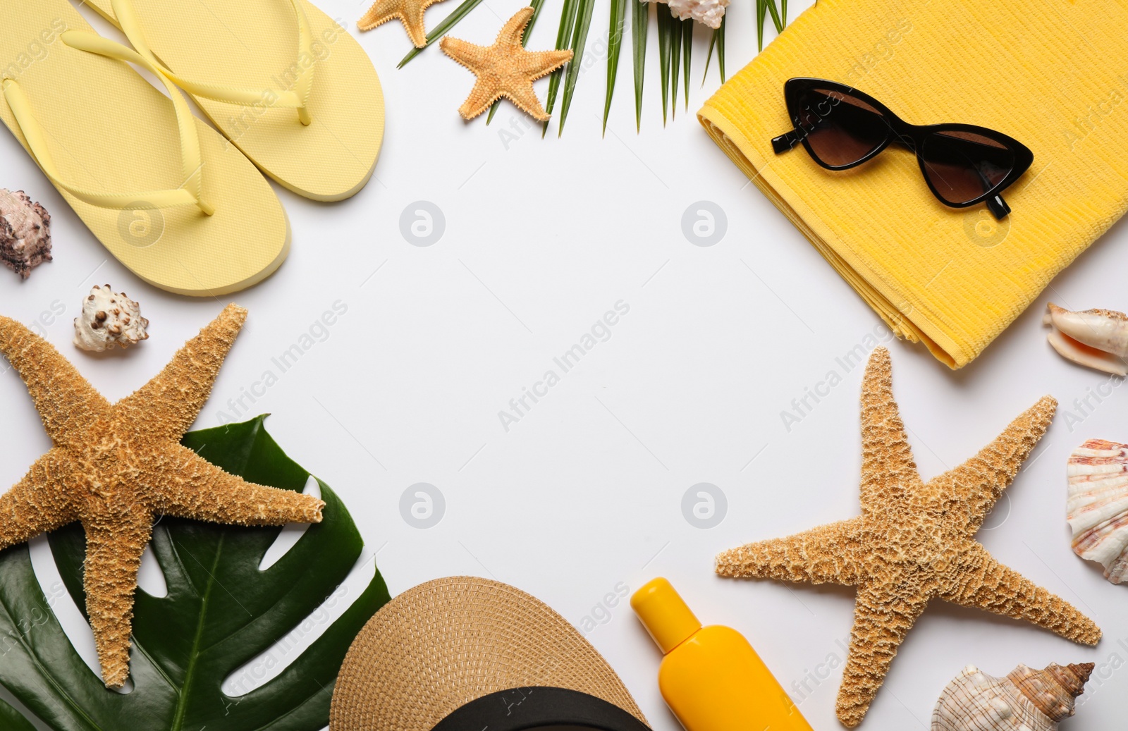 Photo of Frame of different beach objects on white background, flat lay. Space for text