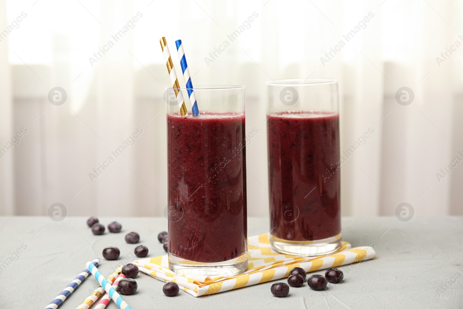 Photo of Glasses with delicious acai smoothie on table