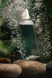 Photo of Bottlemicellar water in liquid on blurred background