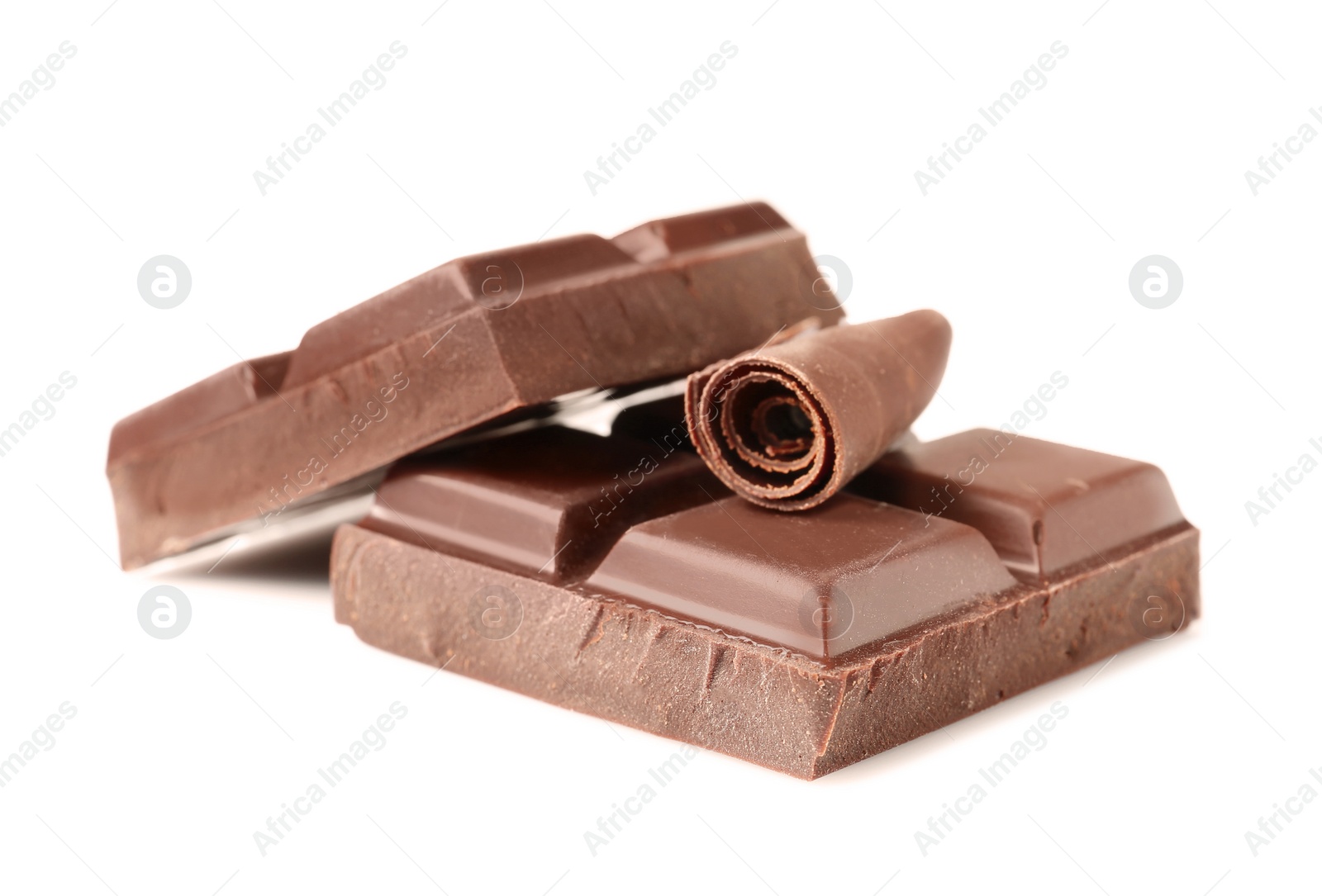 Photo of Yummy chocolate curl and pieces on white background