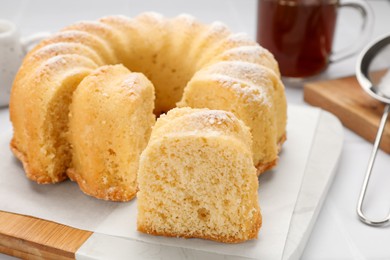 Photo of Delicious freshly baked sponge cake on white table, closeup