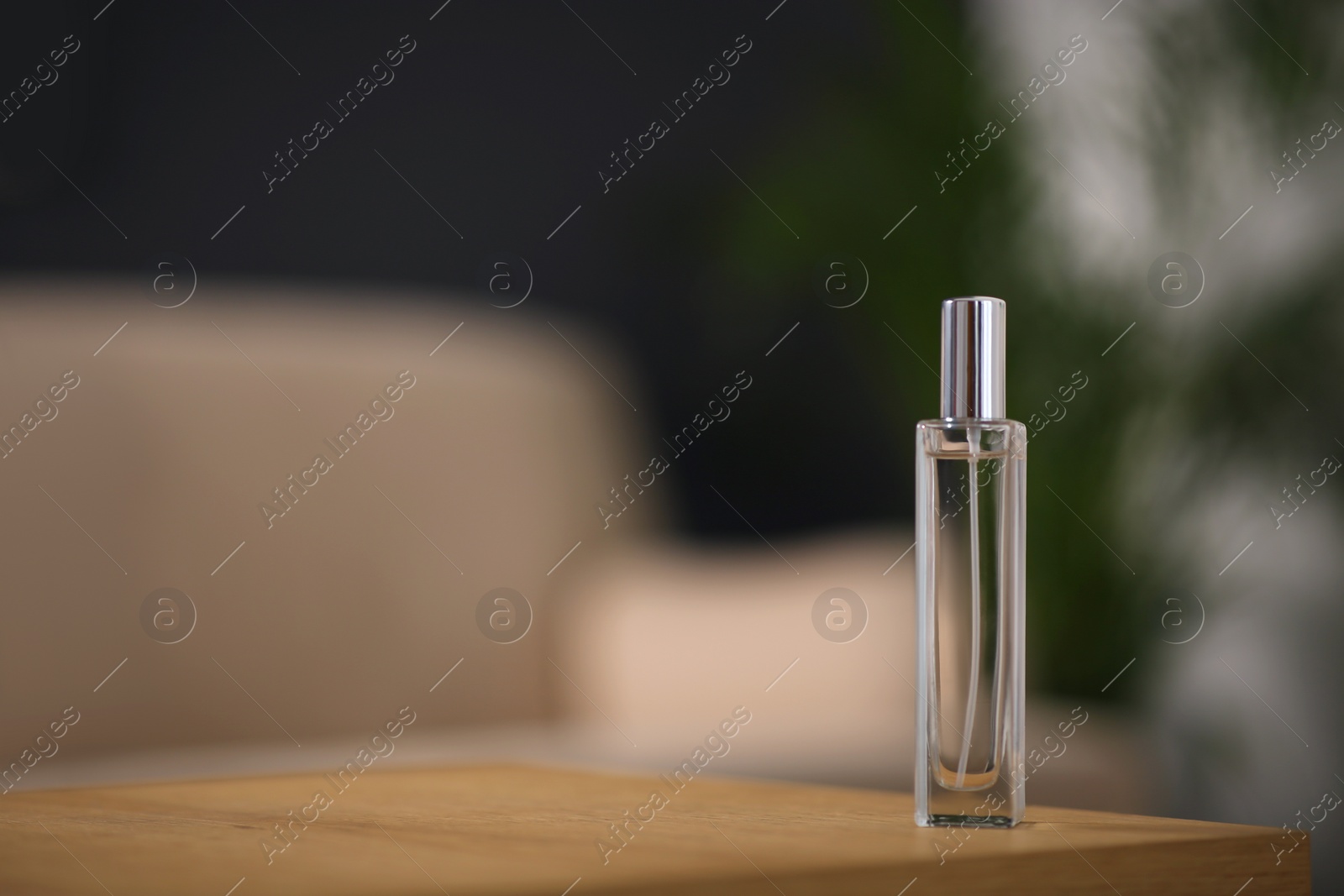 Photo of Air freshener on wooden table indoors. Space for text