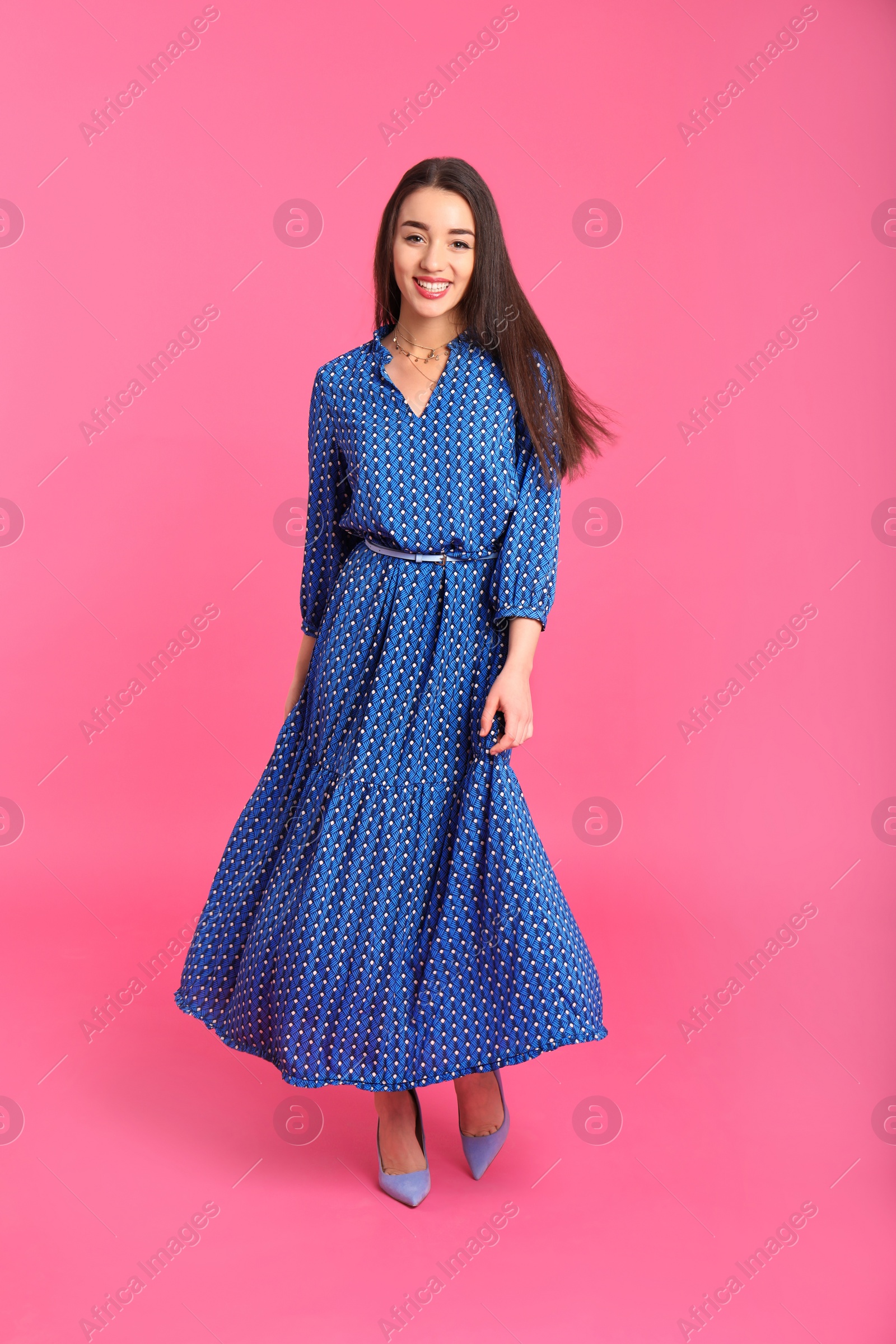 Photo of Portrait of beautiful young woman in stylish dress on color background