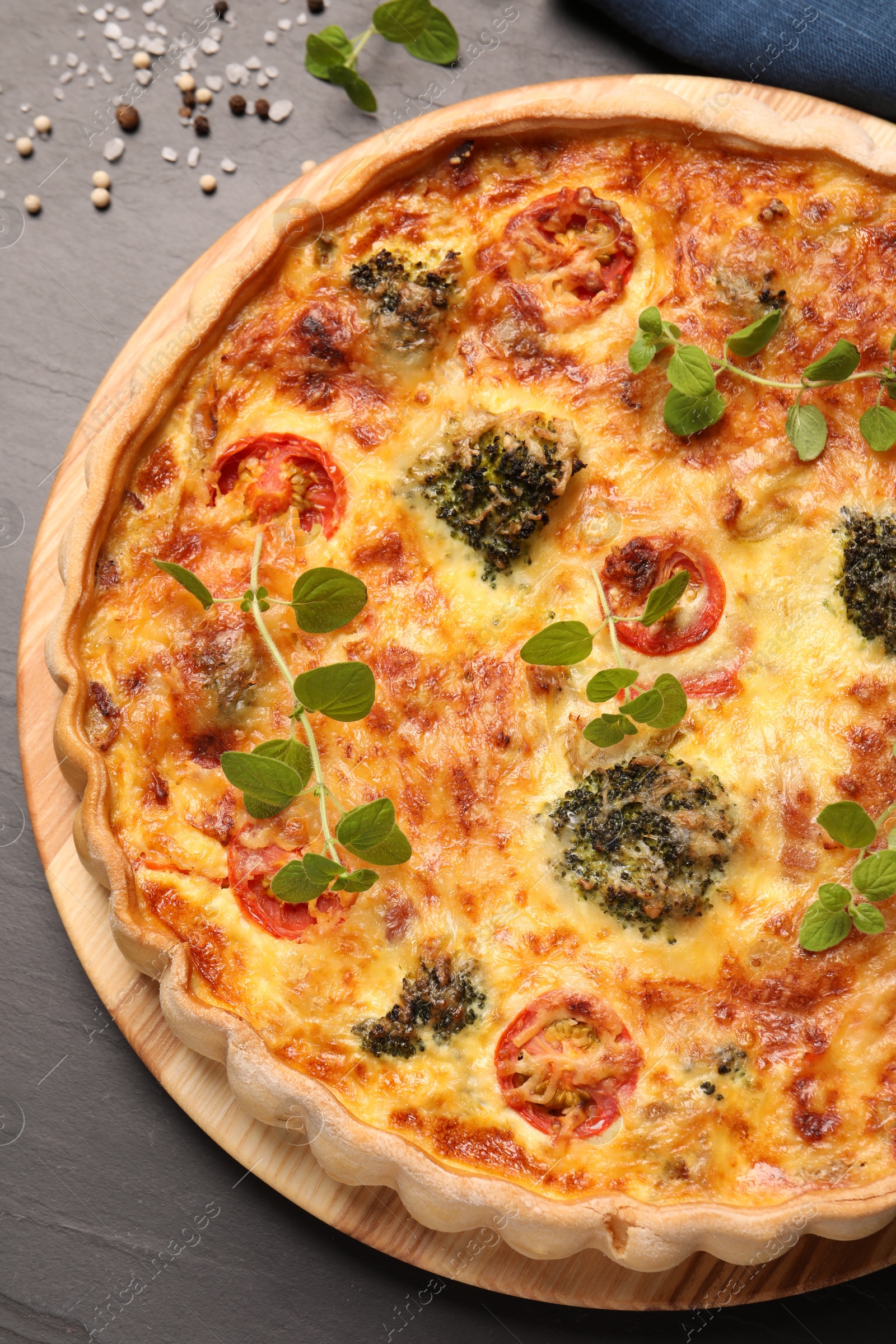 Photo of Delicious homemade vegetable quiche on dark table, top view