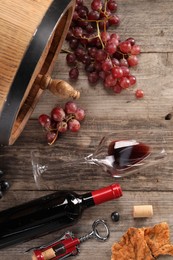 Photo of Winemaking. Flat lay composition with tasty wine and barrel on wooden table