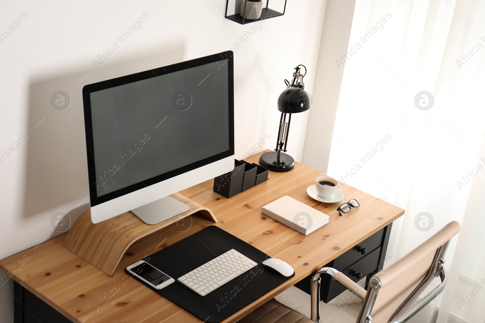 Photo of Stylish workplace interior with modern computer on table. Mockup for design