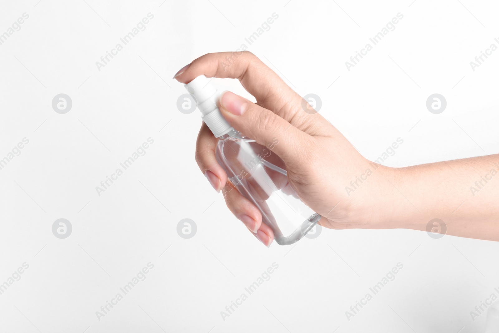 Photo of Woman holding antiseptic spray on white background, closeup