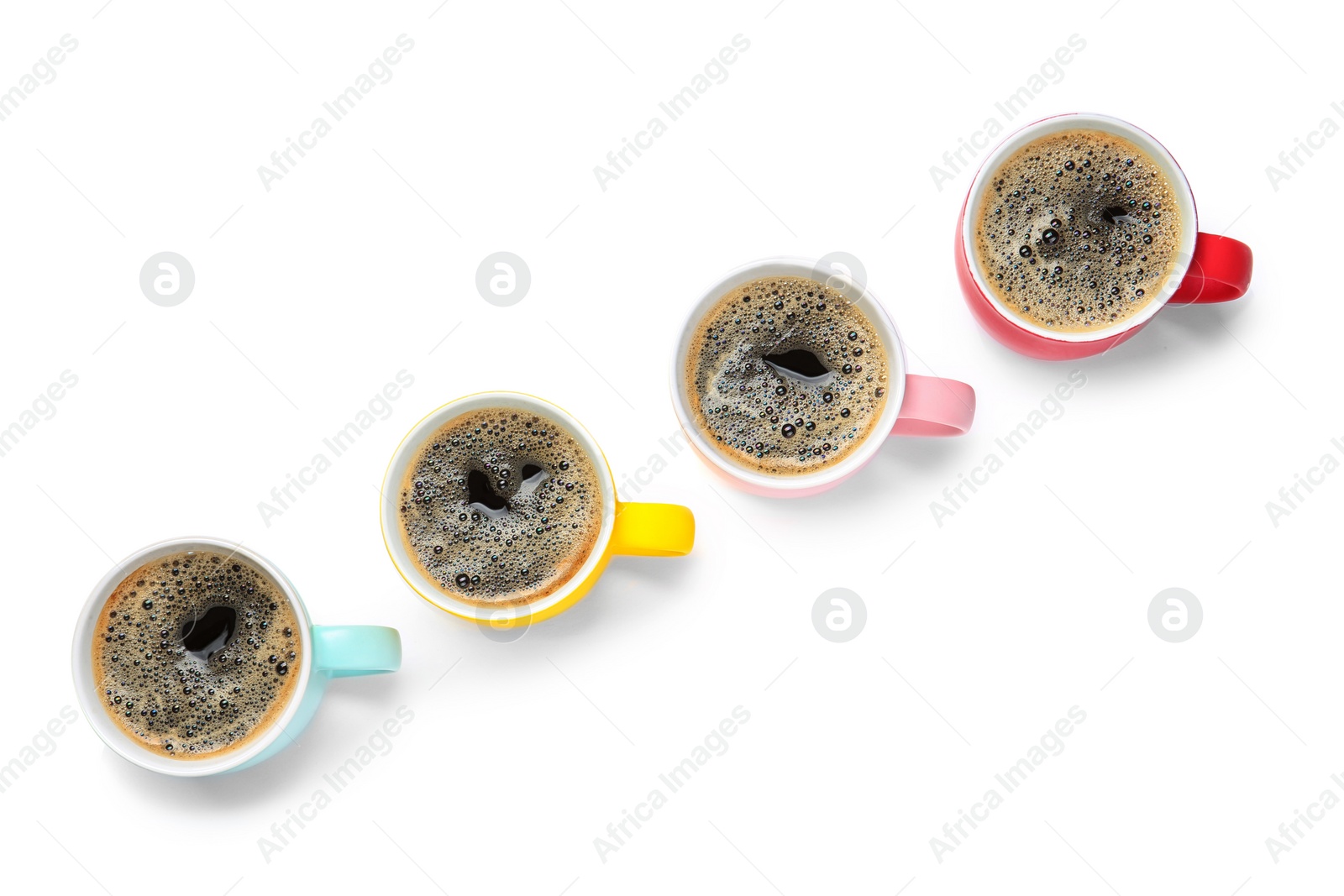 Photo of Row of cups with aromatic coffee on white background, top view