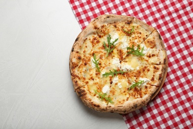 Image of Tasty cheese pizza on white table, top view