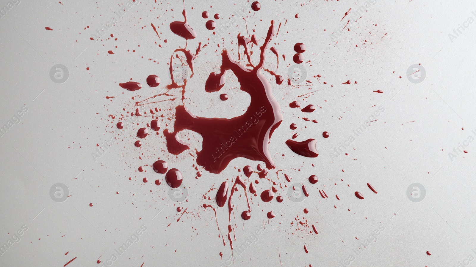 Photo of Stain and splashes of blood on light grey background, top view